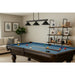 Z-Lite Cobalt Matte Black 3-Light Billiard Pendant over a blue felt pool table in modern game room – sleek matte black finish with adjustable rods